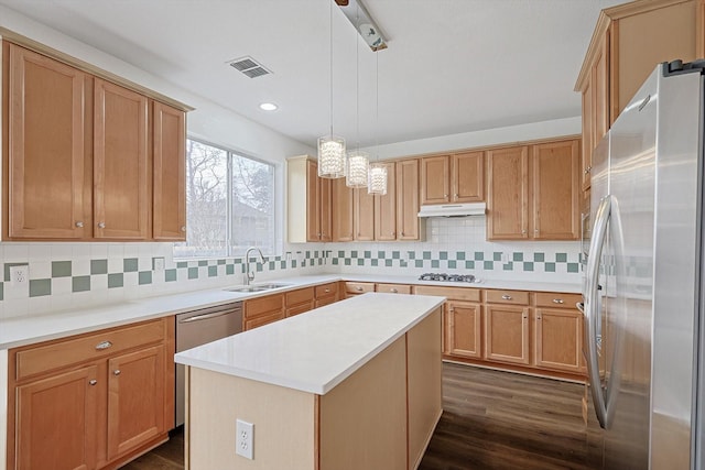 kitchen with visible vents, appliances with stainless steel finishes, a center island, light countertops, and pendant lighting