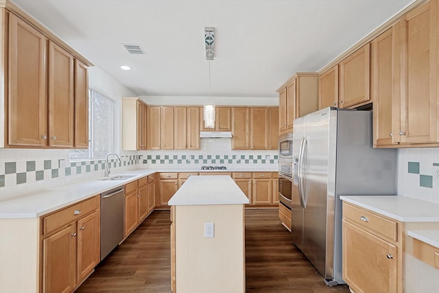 kitchen featuring visible vents, a kitchen island, appliances with stainless steel finishes, and light countertops