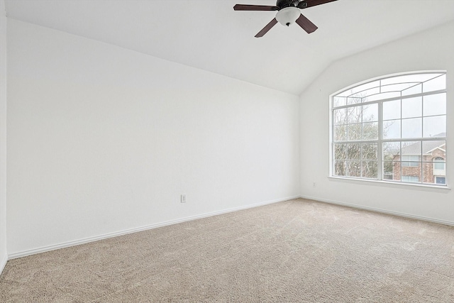 unfurnished room with carpet floors, baseboards, and vaulted ceiling