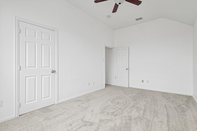 interior space with ceiling fan, light carpet, visible vents, baseboards, and vaulted ceiling