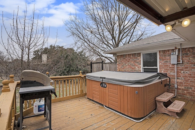 wooden deck with a hot tub