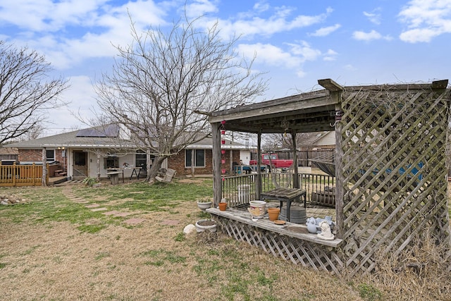 view of yard with fence and a wooden deck