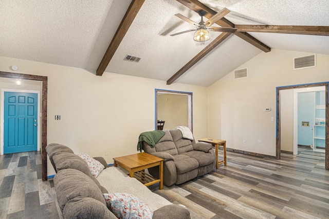 living area featuring visible vents, vaulted ceiling with beams, and light wood-style floors
