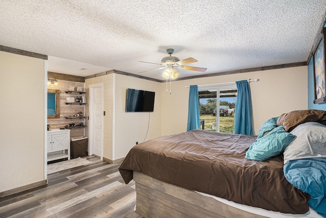 bedroom with baseboards, wood finished floors, ceiling fan, and a textured ceiling