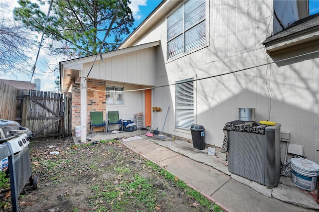 rear view of property featuring a patio area and central air condition unit