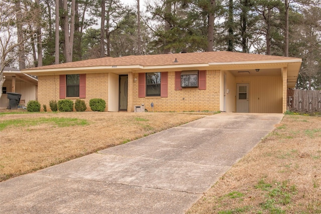 ranch-style house with a carport and a front lawn