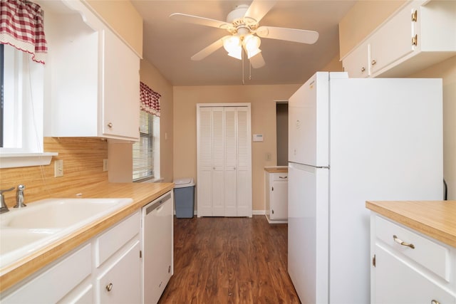 kitchen with white cabinetry, sink, ceiling fan, dark wood-type flooring, and white appliances