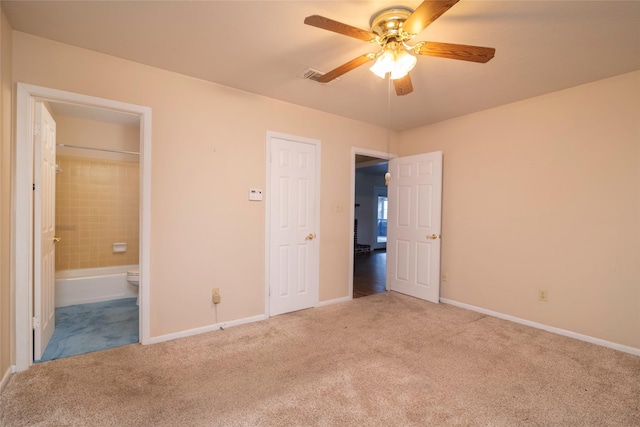 unfurnished bedroom featuring light colored carpet, ceiling fan, and ensuite bathroom