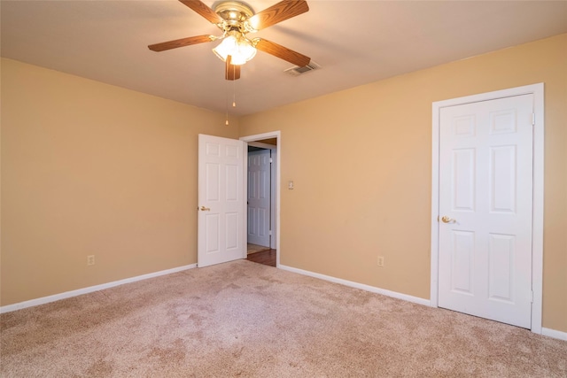 unfurnished bedroom featuring ceiling fan and carpet