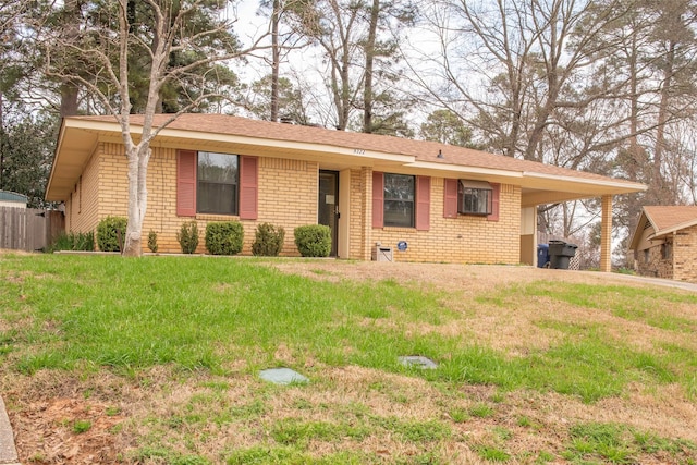 ranch-style home with a carport and a front lawn