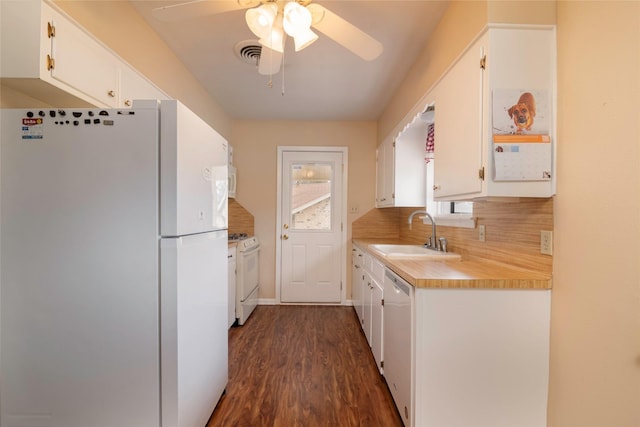 kitchen with tasteful backsplash, sink, white appliances, and white cabinets