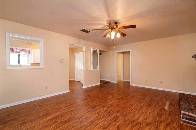 empty room featuring ceiling fan and dark hardwood / wood-style flooring