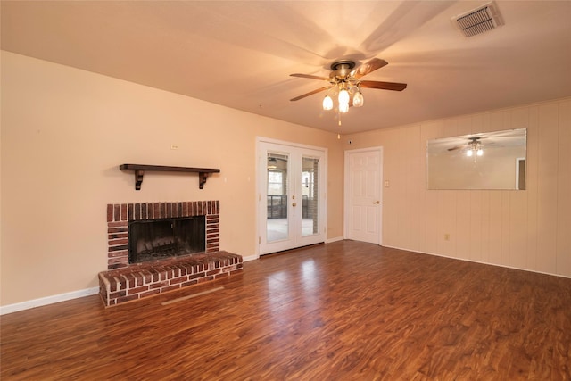 unfurnished living room with dark hardwood / wood-style floors, a fireplace, and ceiling fan