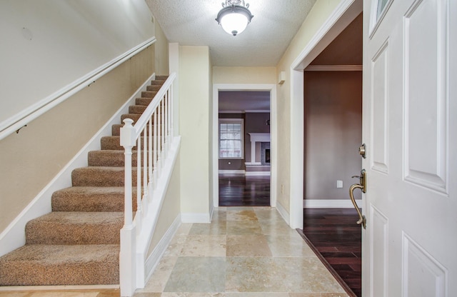 entryway featuring a textured ceiling and light hardwood / wood-style floors