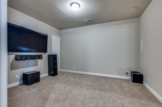 carpeted living room featuring a textured ceiling