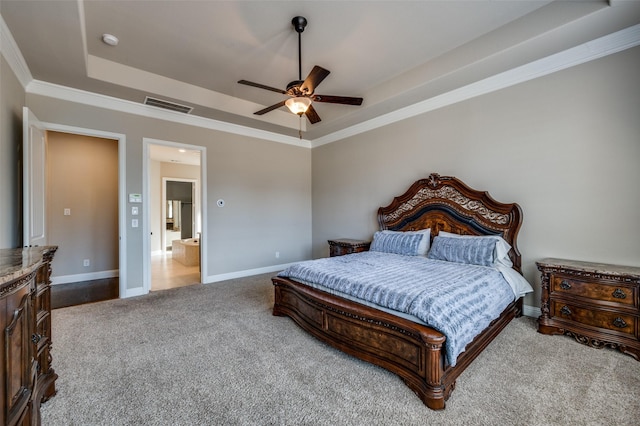 carpeted bedroom with ceiling fan, ornamental molding, and a tray ceiling