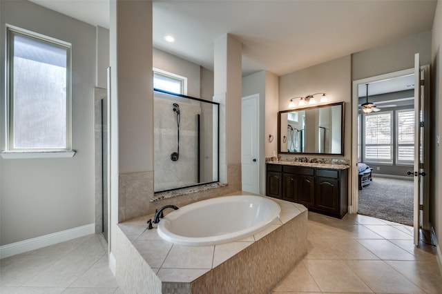 bathroom with tile patterned floors, independent shower and bath, and vanity