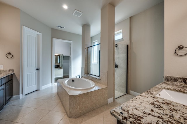 bathroom featuring shower with separate bathtub, tile patterned floors, and vanity