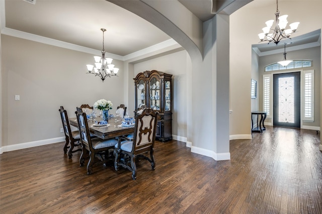 dining space featuring ornamental molding, dark hardwood / wood-style floors, and a chandelier