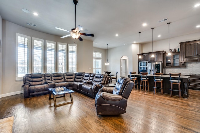 living room featuring ceiling fan and hardwood / wood-style floors