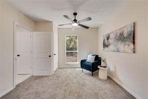 sitting room featuring carpet flooring and ceiling fan