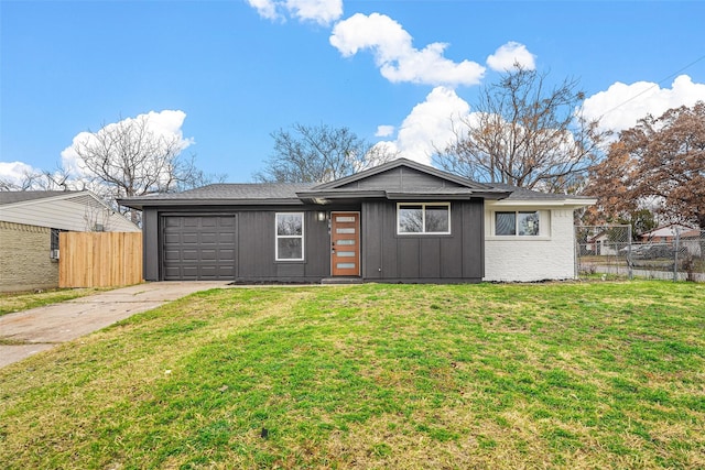 ranch-style home with a garage and a front yard