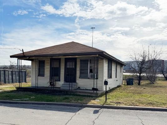 bungalow with a porch and a front yard