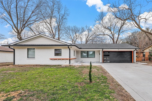 single story home featuring a garage, brick siding, and driveway