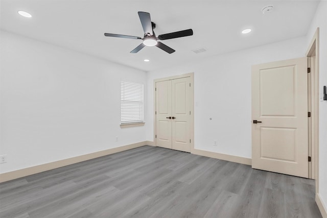 unfurnished bedroom featuring visible vents, recessed lighting, light wood-style flooring, and baseboards