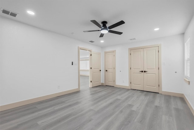 unfurnished bedroom with light wood-style floors, recessed lighting, visible vents, and baseboards