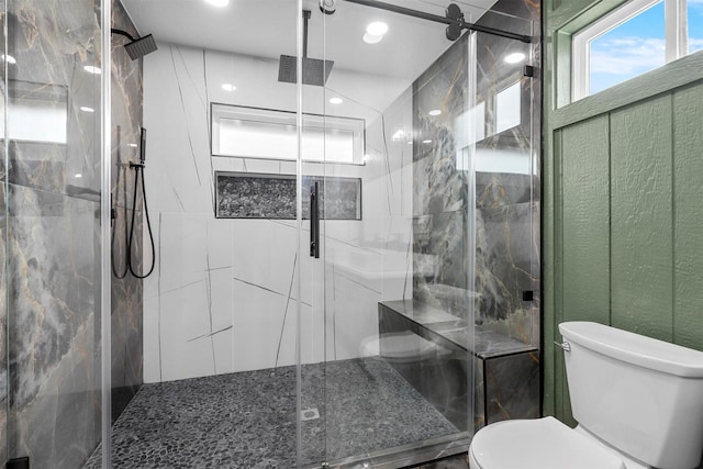 full bath featuring a marble finish shower and toilet