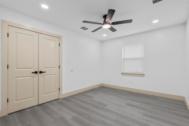 unfurnished bedroom with visible vents, light wood-style flooring, and recessed lighting