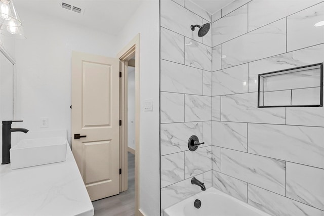 full bathroom featuring bathtub / shower combination and visible vents