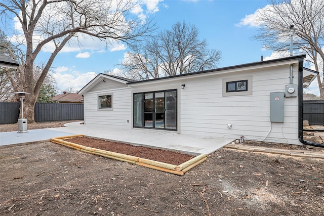 rear view of house featuring a patio area and fence