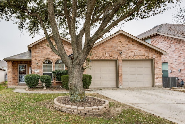 view of front of home featuring a garage and central air condition unit