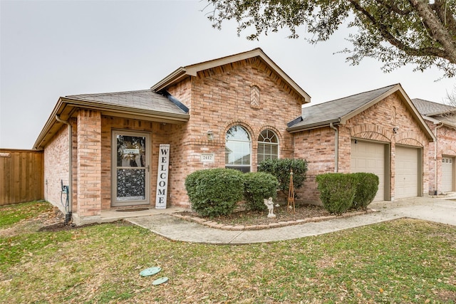 view of front of property with a garage and a front lawn