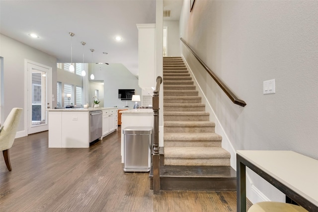 stairs featuring sink and hardwood / wood-style floors