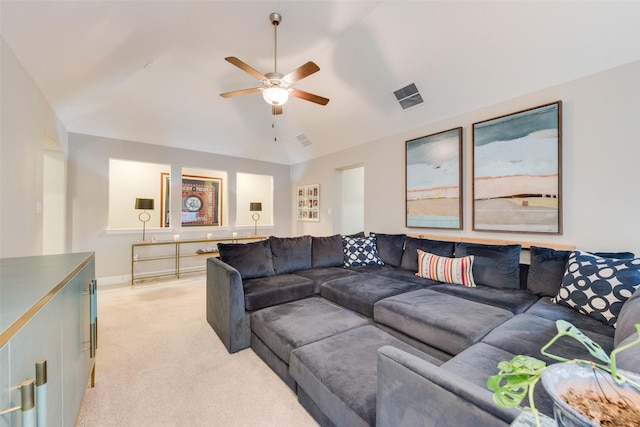 living room with vaulted ceiling, light colored carpet, and ceiling fan