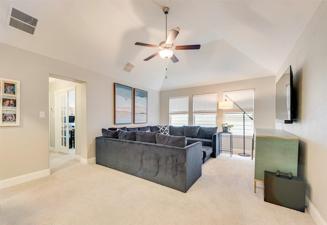 living room with ceiling fan, light colored carpet, and vaulted ceiling