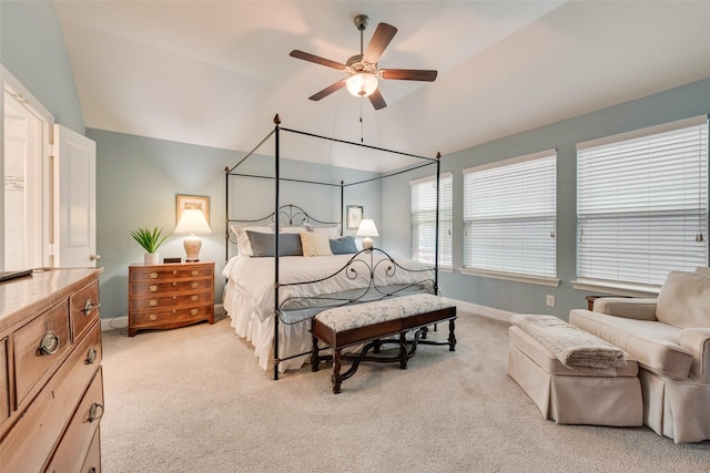 carpeted bedroom featuring lofted ceiling and ceiling fan