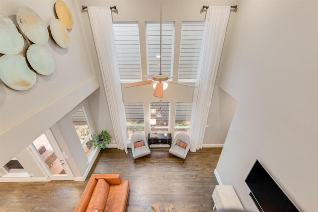 interior space featuring ceiling fan and dark hardwood / wood-style floors