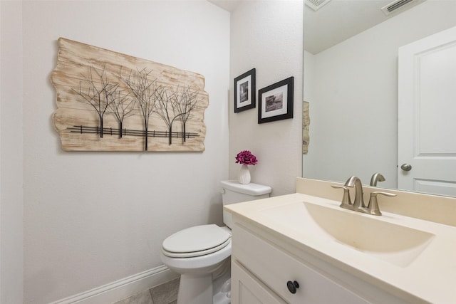 bathroom with vanity, tile patterned floors, and toilet