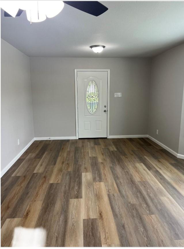 entrance foyer with ceiling fan and dark hardwood / wood-style flooring