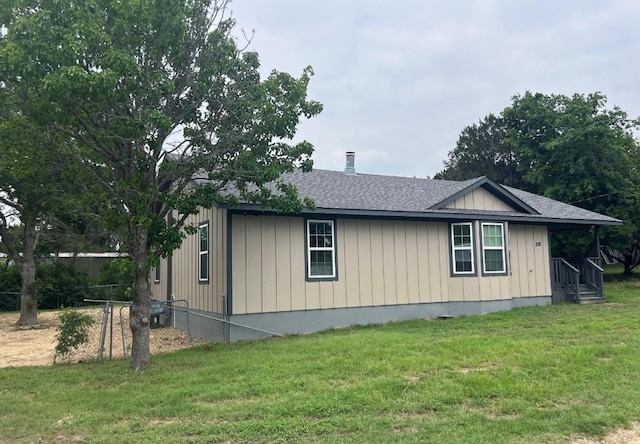 view of side of property with a lawn