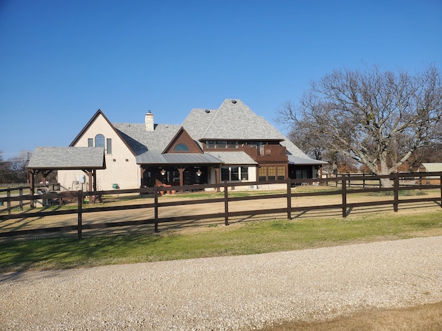 505 Mccormick Rd, Oak Point, TX 75068 - view of front of home with a chimney, fence, metal roof, and a standing seam roof