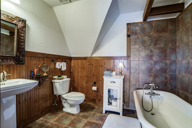 505 Mccormick Rd, Oak Point, TX 75068 - full bath with a bathtub, toilet, wainscoting, vaulted ceiling, and wooden walls