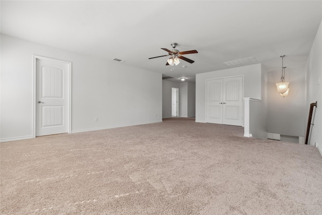 spare room featuring ceiling fan, visible vents, and carpet flooring