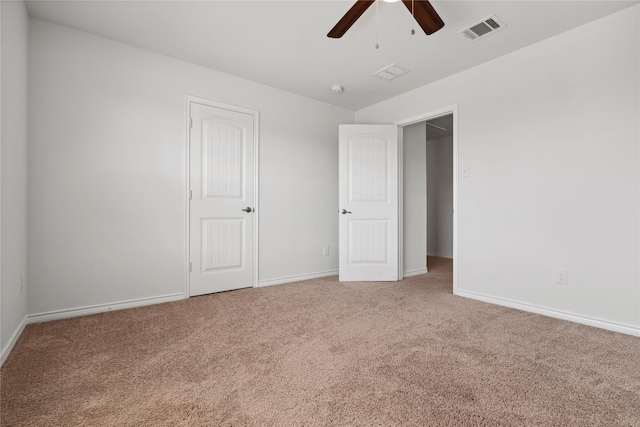 unfurnished bedroom with carpet, visible vents, and baseboards