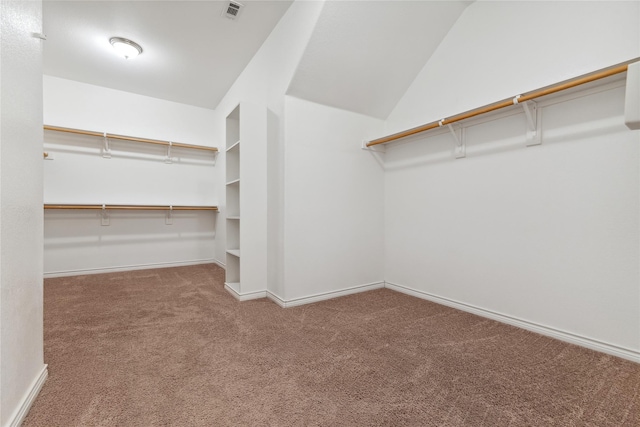 walk in closet with lofted ceiling, carpet, and visible vents