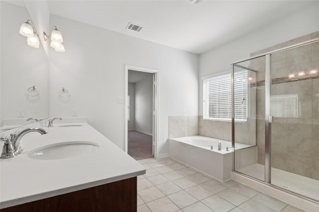 full bathroom with double vanity, a stall shower, tile patterned floors, a sink, and a bath